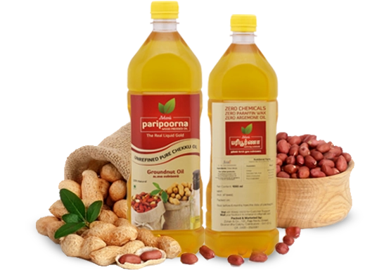 Two bottles of groundnut oil displayed alongside whole peanuts and peanut kernels in the foreground