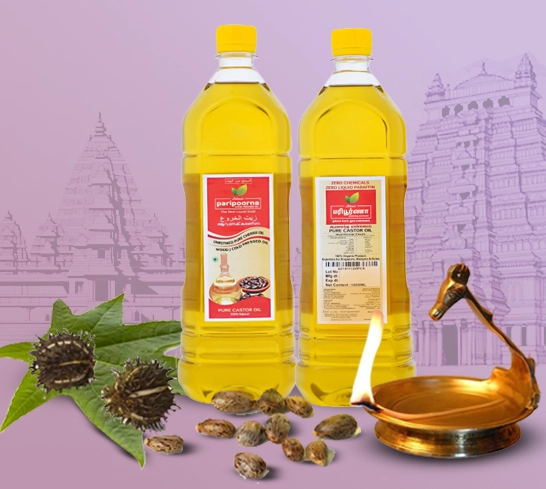 Two bottles of cooking oil with castor leaves and seeds, and a brass lamp, against a temple backdrop.
