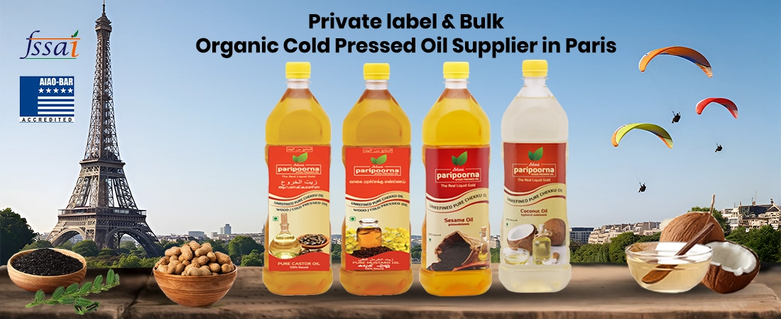 Bottles of cold-pressed sesame, coconut, and mustard oil with Eiffel Tower in the background.