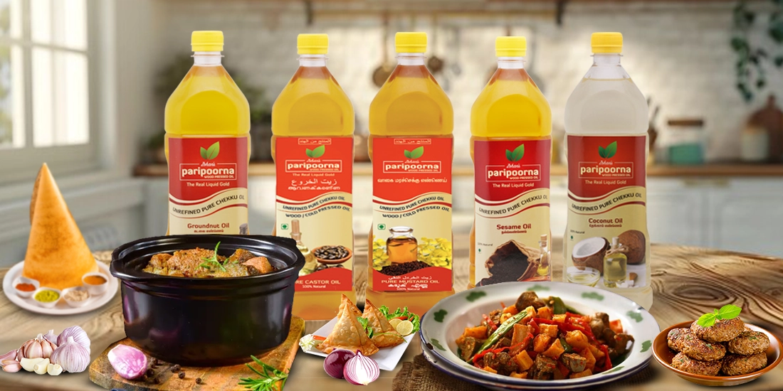 Five cooking oil bottles with various dishes like samosa and curry, placed on a wooden surface.
