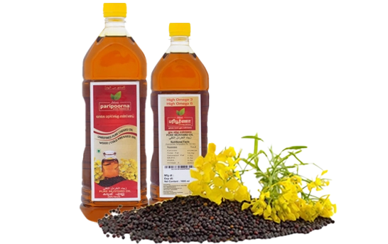 Two bottles of cooking oil alongside a mound of mustard seeds and vibrant yellow flowers in front.